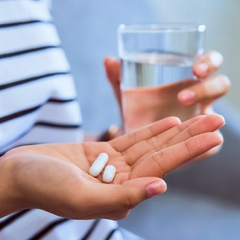 a dental patient holding a pill