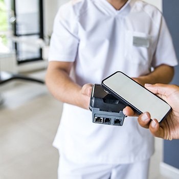 A patient paying for braces with their smartphone