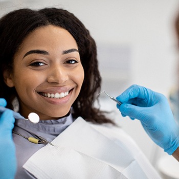 a patient smiling during a dental visit