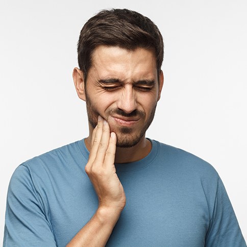 Frowning man suffering from oral pain