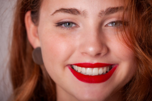 Patient showing off her bright smile and flawless skin