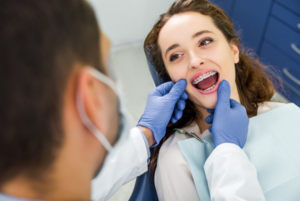 Dentist checking patient’s braces