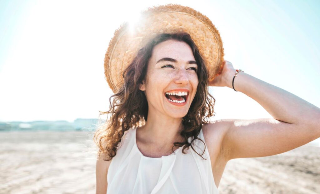 A woman smiling on the beach